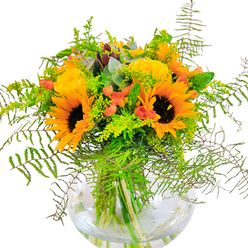 Bromley Common's sunniest moments come alive in this abundant floral arrangement, showcased in a gracefully rounded glass vase. Radiant sunflowers lead the display, their velvety, deep brown centers framed by bold whorls of yellow and orange, infusing the bouquet with the glow of a local summer afternoon. Tucked among these are yellow garden roses, their layers of petals swirling open with classic elegance, exuding a subtle yet uplifting scent. Hypericum berries-polished and red as cherries at Bromley's Green Street Market-are peppered throughout, providing sparkling pockets of colour and visual delight. The rich greenery forms a lush base, with arching fronds of fern spilling delicately over the rim, echoing the textures found in Jubilee Country Park. Sprigs of golden solidago with tiny blossoms and slender green spikes add a breezy, meadow-like touch, while eucalyptus leaves introduce a blue-green softness that cools the composition. Each angled stem anchors the arrangement, visible through the pristine glass as it rests in fresh, clear water, lending structure and lightness. Run your fingers across the bouquet's edge and you'd feel contrasts: suede-like sunflower petals, the plush embrace of roses, and glossy leaves. This piece by Bromley Common Flowers is crafted for celebrations-birthdays, thank-you notes, or simply sharing a bright day with family and friends-delivering a beautiful snapshot of Bromley Common's seasonal radiance.